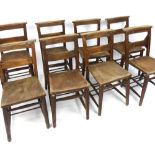 Set of eight chapel chairs, elm solid saddle seats, prayer book trough, turned legs and stretchers,