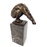 Bronze sculpture of an athletic man, in a yoga pose, black variegated plinth,