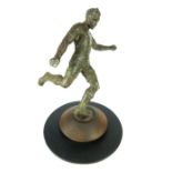 Mid 20th C statue of a footballer, action shot in mid strike of the football, bronzed spelter,