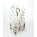 19th C silver cruet stand, laurel ring handle, five bottle rings on ball and claw feet,