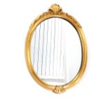 20th century gilt framed oval wall mirror, foliate and shell decoration,