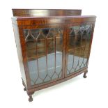 An early 20th C mahogany bookcase / display cabinet, the bow front with astragal glazed doors,