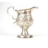 George III silver cream jug, bead decoration to rim and foot, repousse floral and bird body,