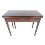 George III mahogany fold over tea table with single drawer & oval brass ring handle on reeded