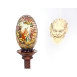 A large 20th century Satsuma porcelain egg on stand, richly decorated with