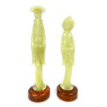 A pair of carved jade figures of a male and female standing in traditional position