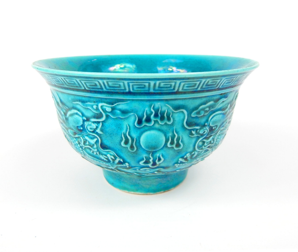 Chinese rice bowl, turquoise glaze, relief decoration of dragons and flaming pearl over the seas,