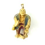 An Antique Japanese Netsuke pendant 19th century, the carved ivory netsuke modeled as a standing