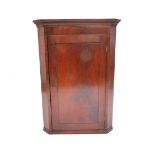 A George III flame mahogany hanging corner cupboard, with single panel door, 95cm high