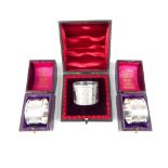 A cased pair Sterling silver napkin rings Birmingham 1964, and cased Victorian Solid silver napkin