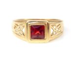 A gentleman's 9ct yellow gold garnet ring, set with square cut garnet with pierced Celtic design