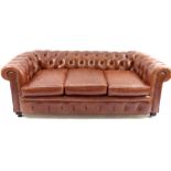 Contemporary leather Chesterfield sofa on aged frame with oak bun feet, mid brown buttonback roll