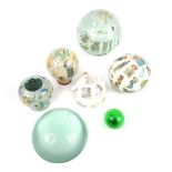 Group of glass spheres with internal decoration, and a glass tabletop magnifying lens 14.5cm dia