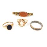 A small selection of gold jewellery comprising an onyx ring, an eternity ring and a cameo ring