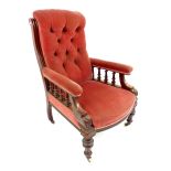 A late Victorian walnut framed gentleman's open armchair, the buttoned back red velvet back above