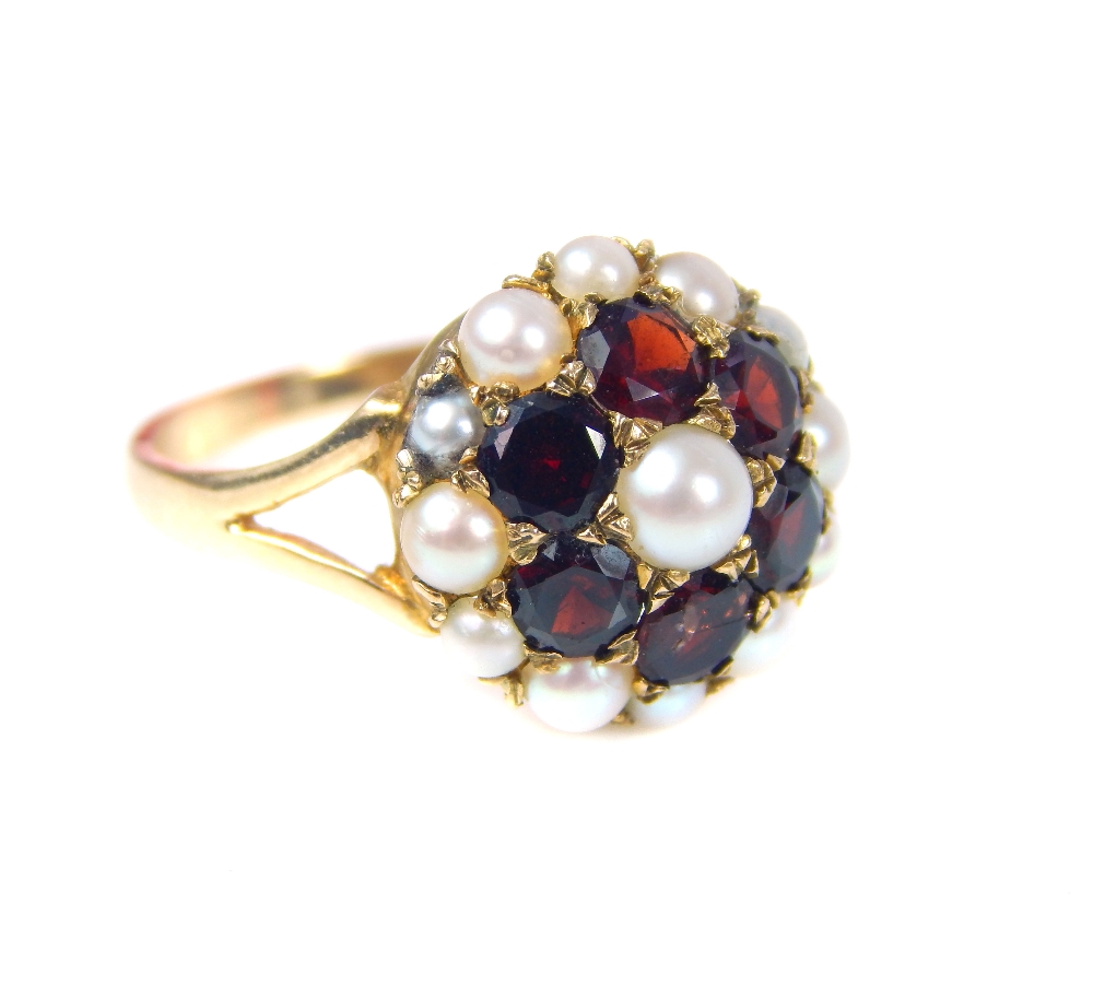 A 9ct yellow gold garnet and seed pearl flowerhead cluster ring, with pierced shoulders. - Image 4 of 4