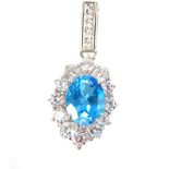 Contemporary blue topaz and cubic zirconia (CZ) set in silver oval shaped pendant, 3cm long