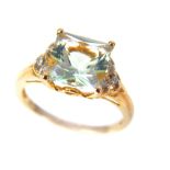 A 9ct yellow gold square cut aquamarine and diamond ring, the square aquamarine flanked by three