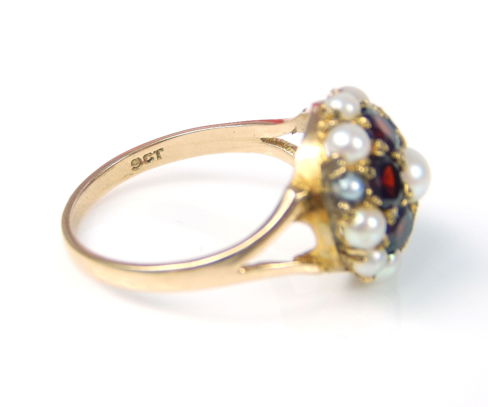 A 9ct yellow gold garnet and seed pearl flowerhead cluster ring, with pierced shoulders. - Image 3 of 4