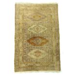 A small antique handwoven Persian silk rug, 115 x