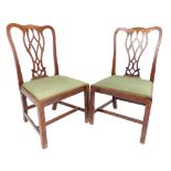 A pair of Georgian mahogany dining chairs, in the