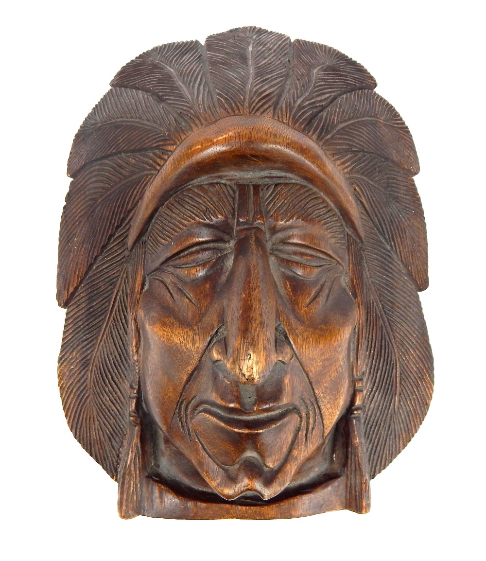 A lifesize carved wooden wall hanging of a North A