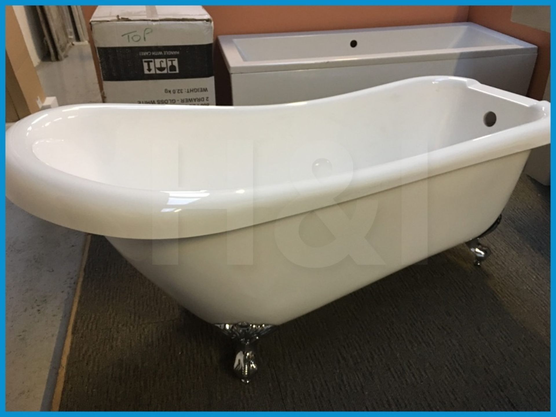 Stunning designer freestanding slipper bathtub with roll top and ornate metal feet. 1700 x 800.