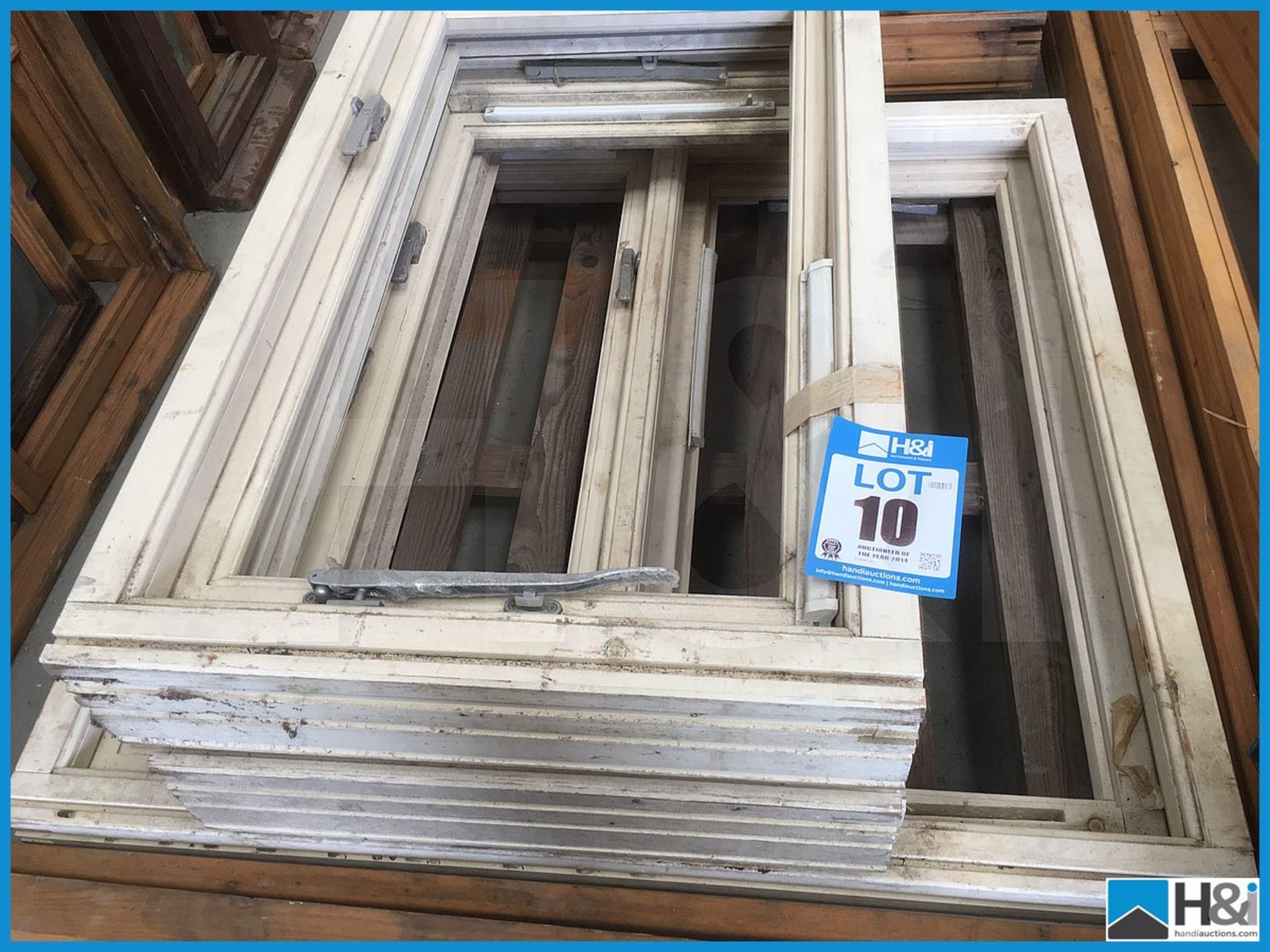 Selection of various unused wood, unglazed casement windows. Dusty appearance due to storage