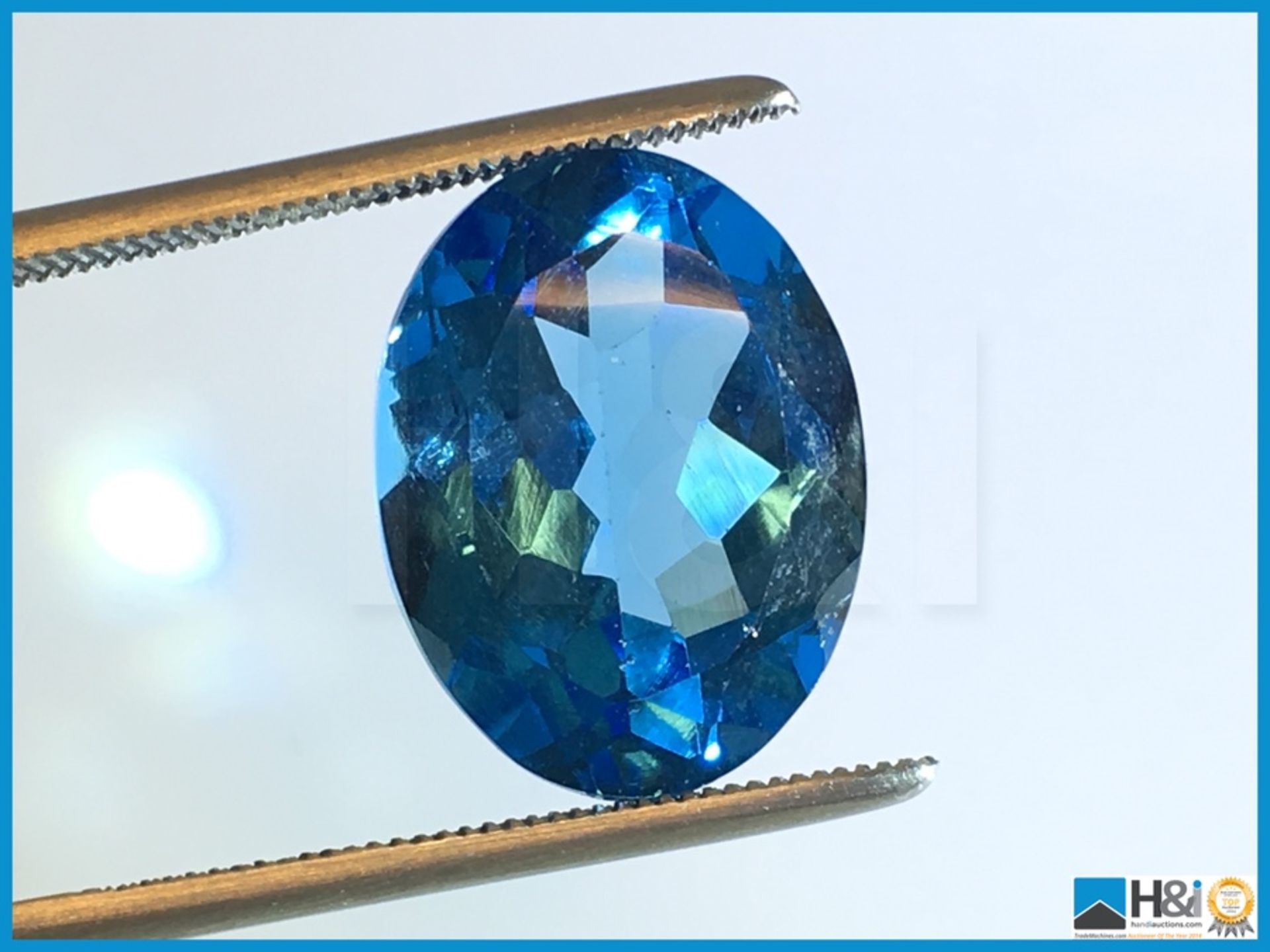 11.98ct Natural Topaz. Oval Cut in Blue. Transparent. Size: 21.17x17.38x12.70mm. Certification: None - Image 4 of 4