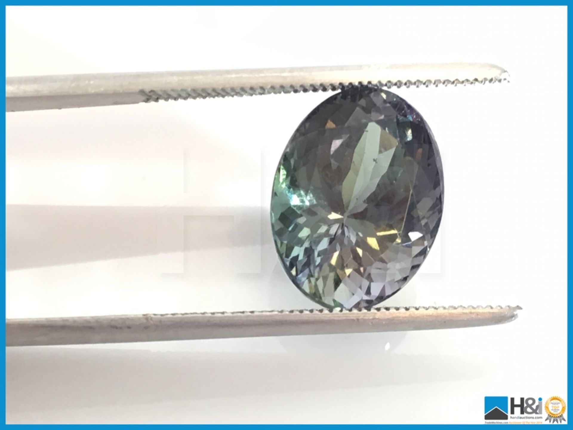 7.57ct Zoisit,Oval Fancy Cut in Violetis Green. Transparent with IGI Certificate 12.99x9.80x8. - Bild 3 aus 4