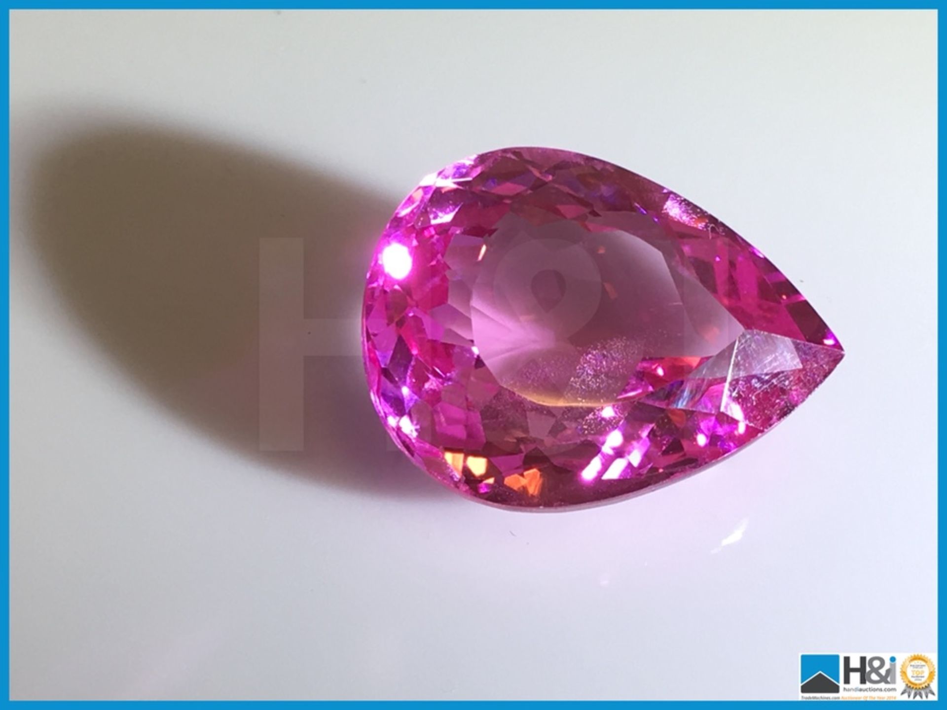 16.58ct Natural Topaz. Pear cut in Strong Pink. Transparent. Size: 23.41x19.18x13.19mm.
