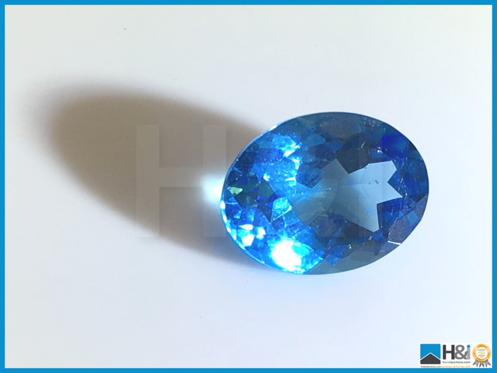 11.98ct Natural Topaz. Oval Cut in Blue. Transparent. Size: 21.17x17.38x12.70mm. Certification: None - Image 3 of 4