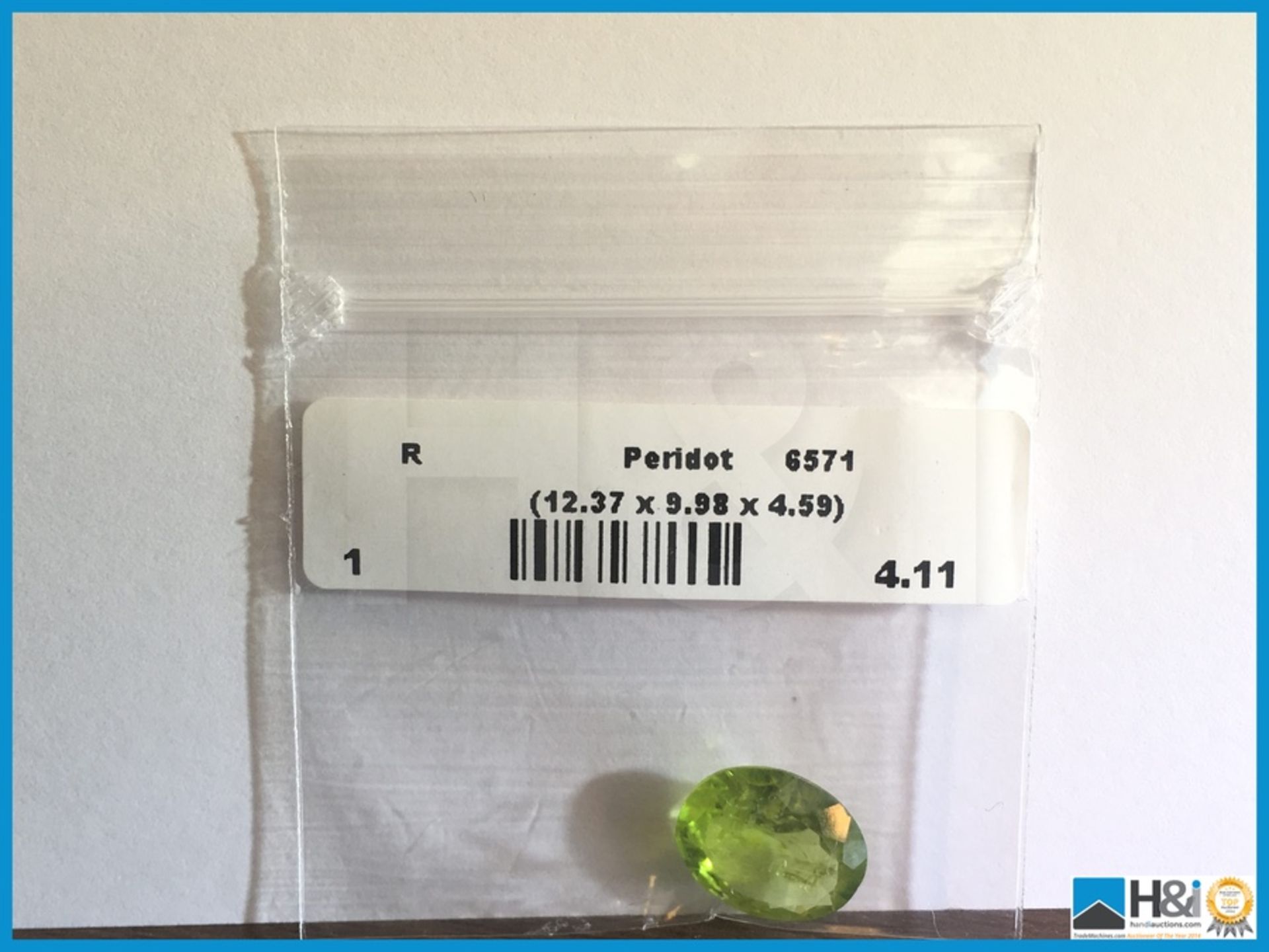 4.11ct Natural Peridot. Oval cut in Green. Size: 12.37x9.98x4.59mm. Certification: None Appraisal: - Image 4 of 4