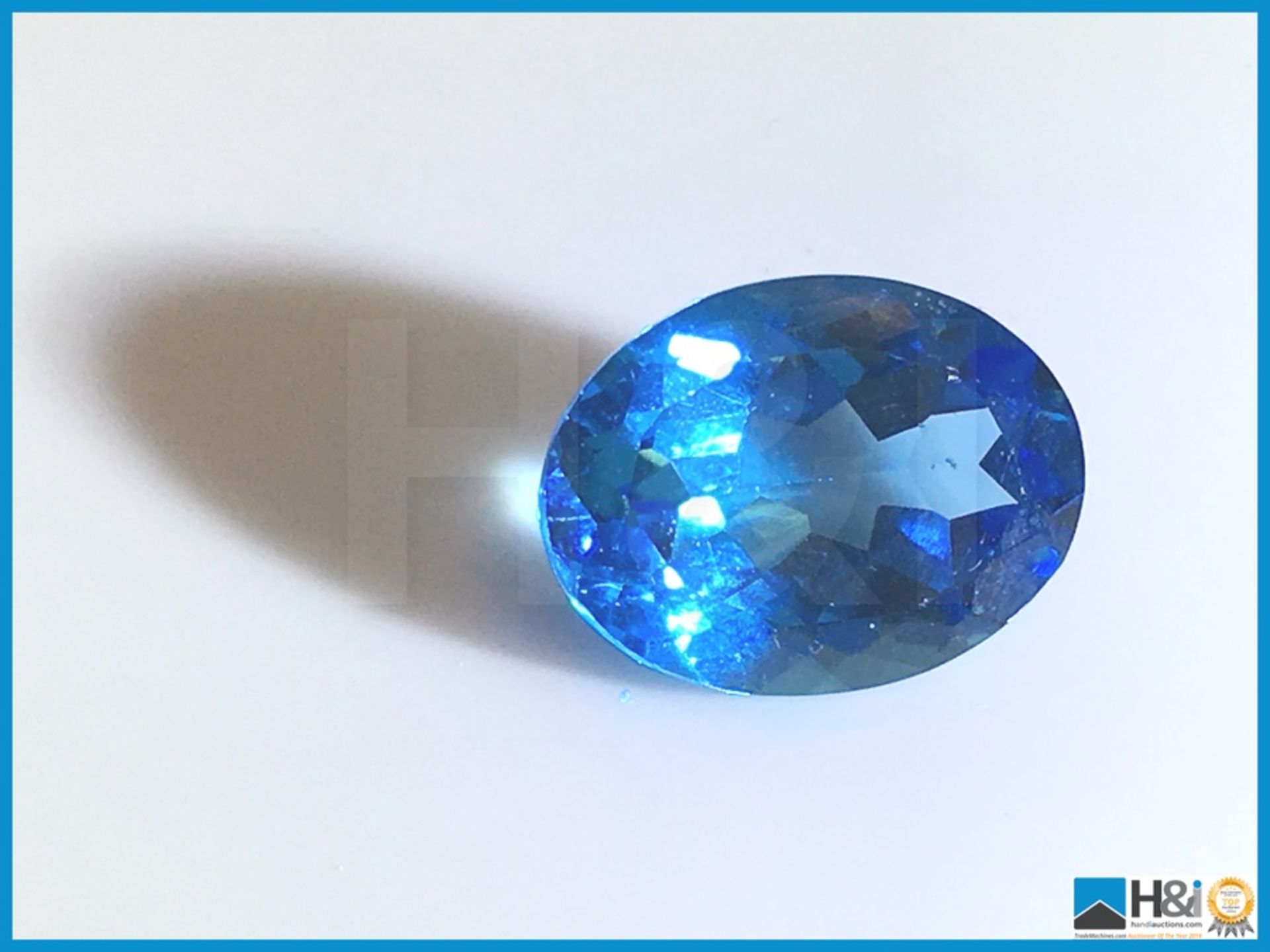 11.98ct Natural Topaz. Oval Cut in Blue. Transparent. Size: 21.17x17.38x12.70mm. Certification: None