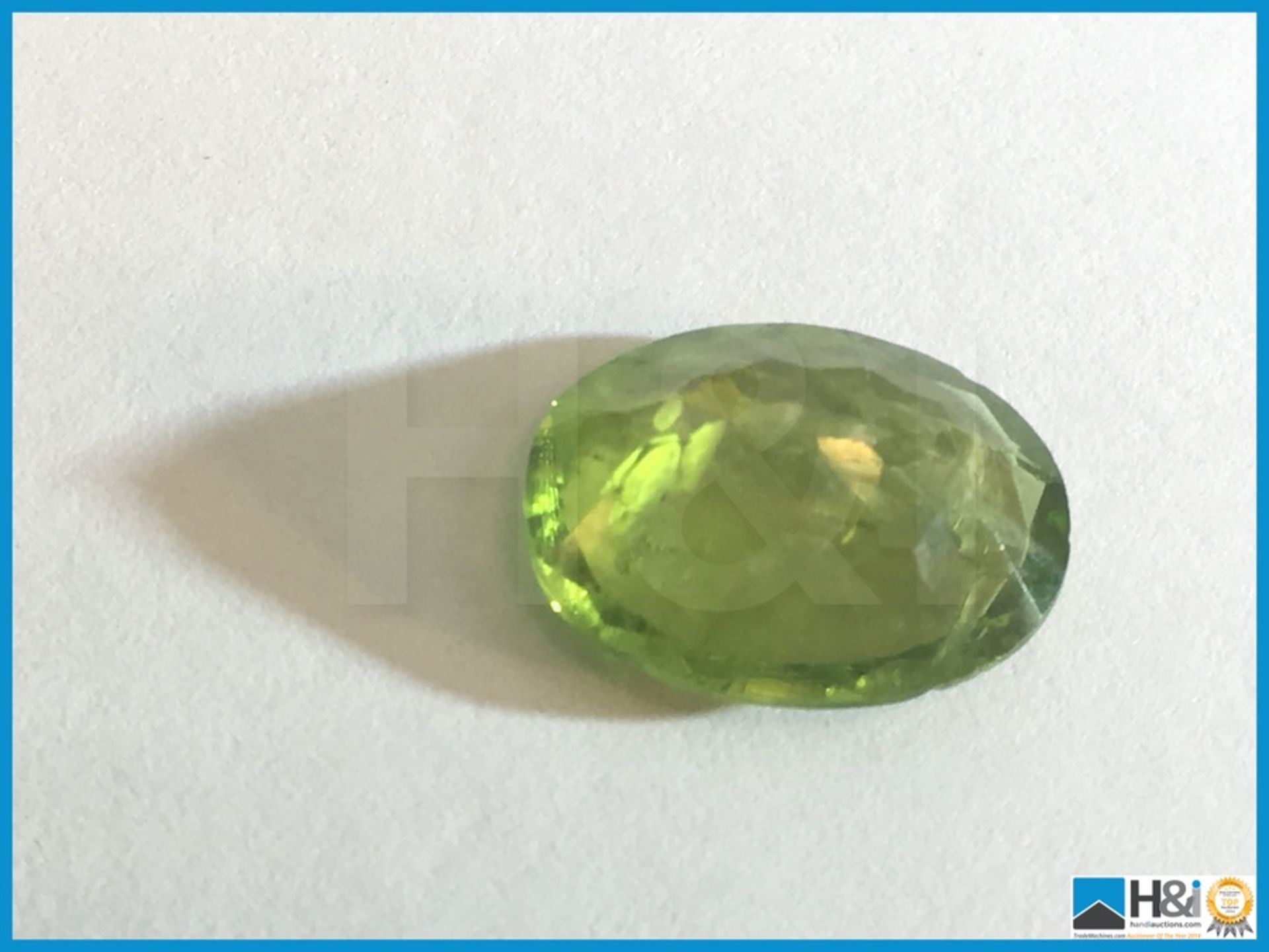 4.11ct Natural Peridot. Oval cut in Green. Size: 12.37x9.98x4.59mm. Certification: None Appraisal: - Image 3 of 4