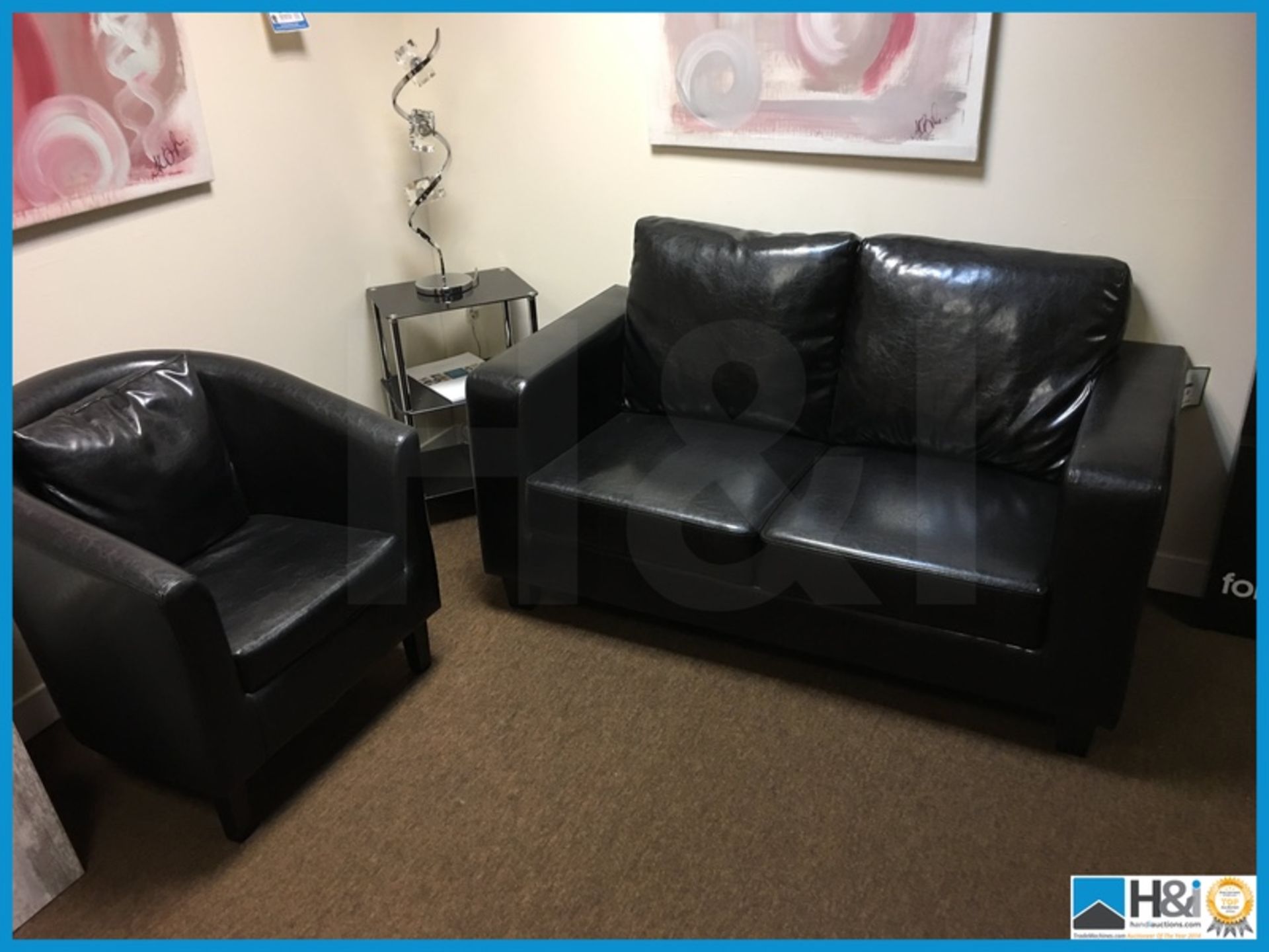 Black leather sofa and chair and glass top table with lamp and canvas art to wall Appraisal: - Image 2 of 7