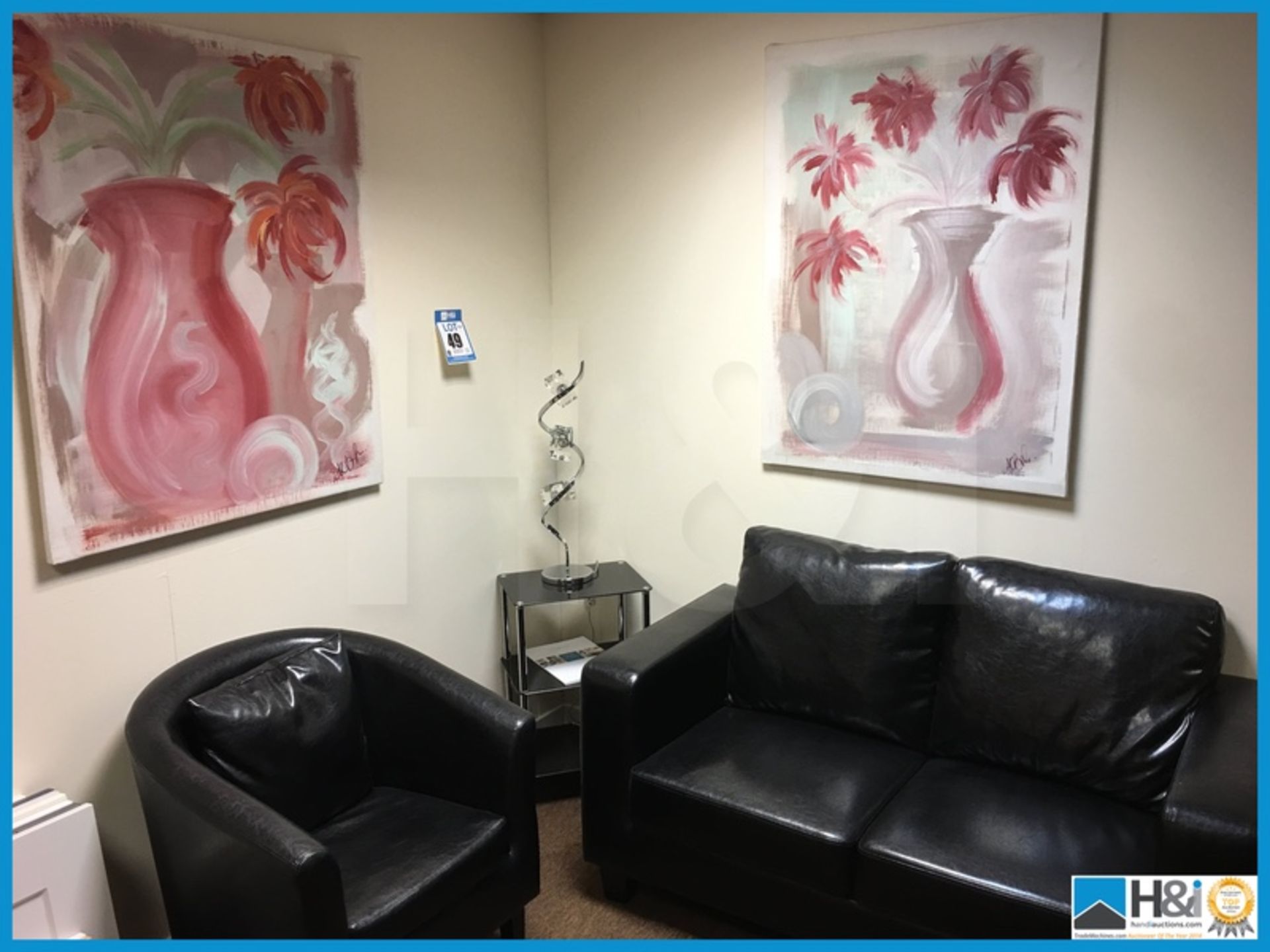 Black leather sofa and chair and glass top table with lamp and canvas art to wall Appraisal: