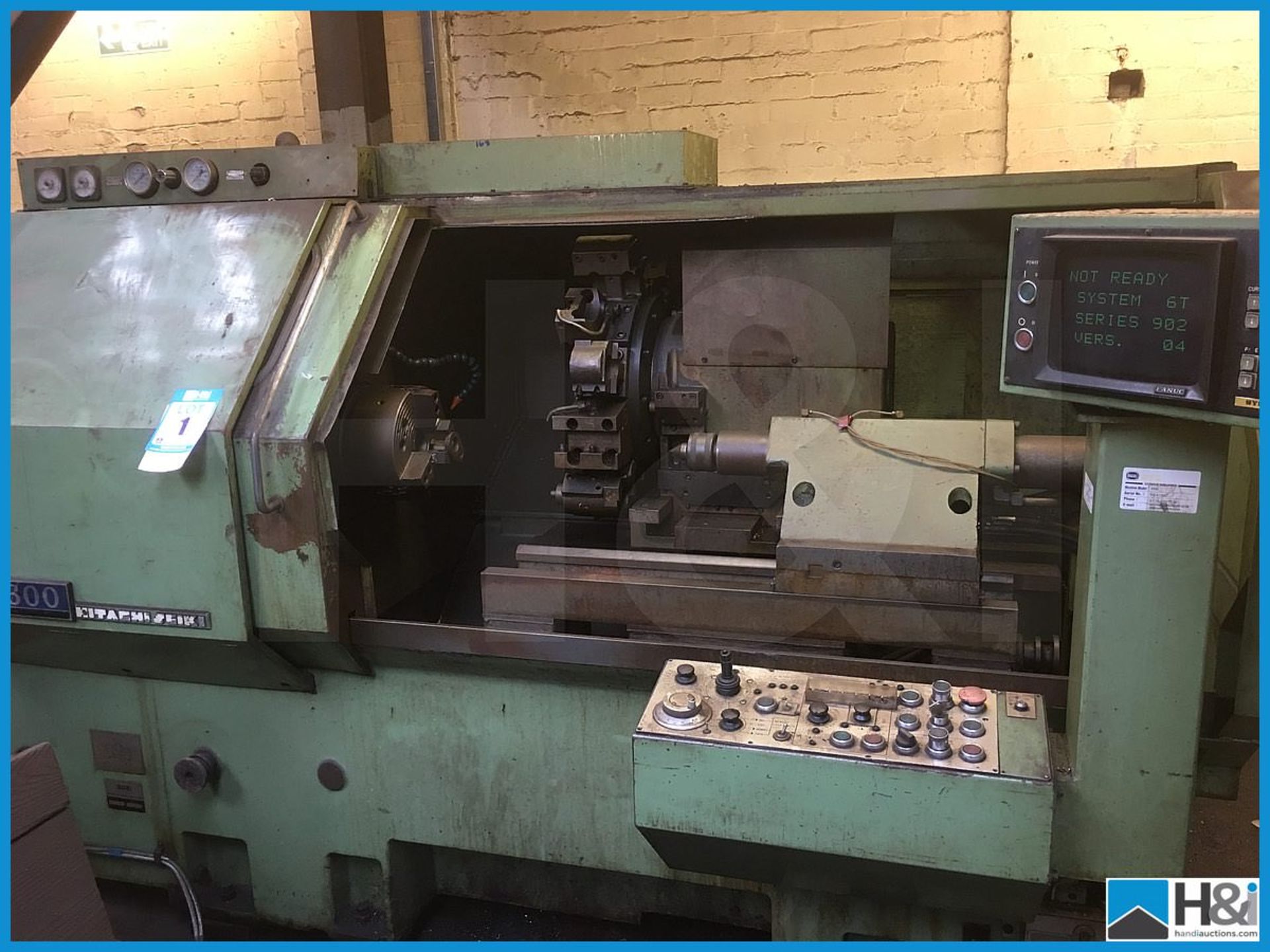 Hitachi Seiki 4NE II-600 CNC lathe machining center with original user manuals. Comes with swarf