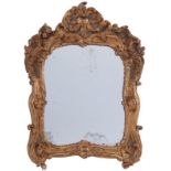 Miroir de style Louis XV- XXe s.- en bois sculpté et doré à décor de coquilles- fleurs et feuilles