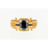 Bague en or 750 sertie d'un saphir taille ovale (env. 1 ct) entouré de diamants taille brillant-