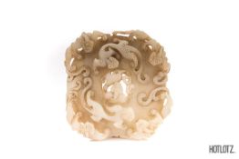 A CHINESE JADE BI DISC WITH MYTHICAL BEASTS