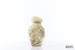 A CHINESE JADE FRUITING VINE VASE AND COVER