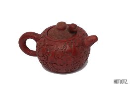 A CHINESE RED LACQUERED POTTERY TEAPOT