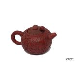 A CHINESE RED LACQUERED POTTERY TEAPOT