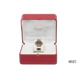 CARTIER - A SANTOS ROUND QUARTZ 18K YELLOW GOLD AND STAINLESS STEEL WATCH (16551)