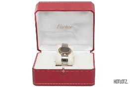 CARTIER - A SANTOS ROUND QUARTZ 18K YELLOW GOLD AND STAINLESS STEEL WATCH (16551)