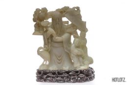 A CHINESE CARVED JADE IMMORTAL