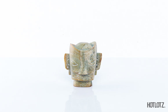 A CHINESE CARVED STONE HEAD