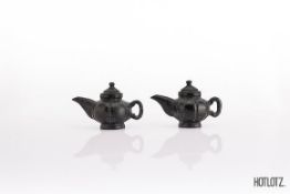 A PAIR OF CHINESE SMALL CARVED STONE TEAPOTS