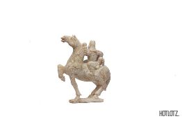 A CHINESE CARVING OF A HORSE AND RIDER